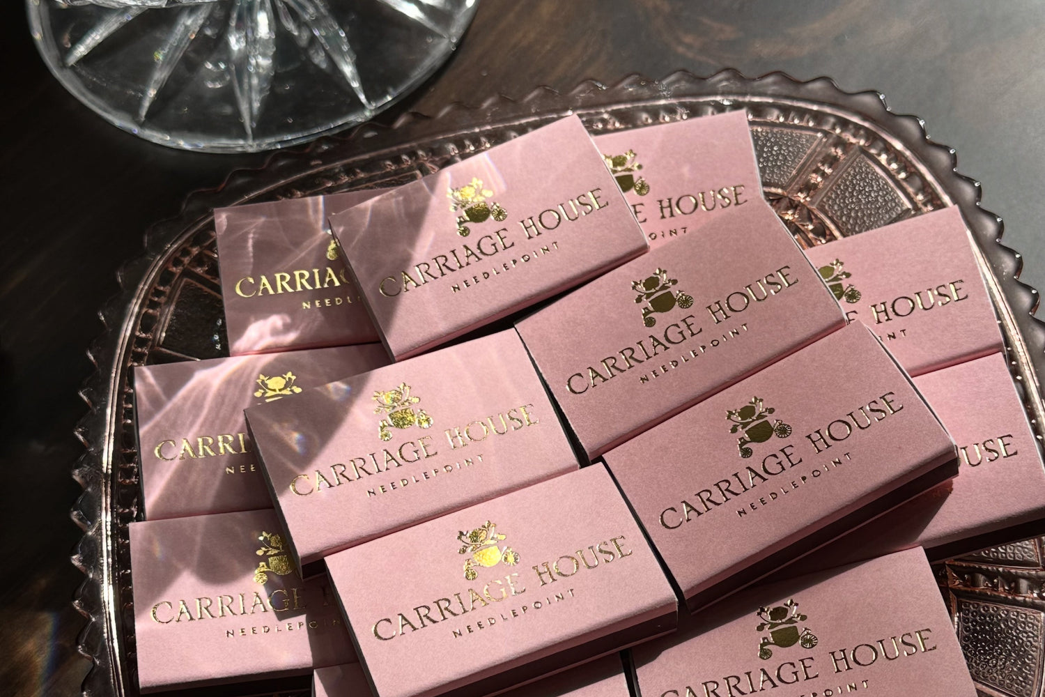 Pink Carriage House matchboxes on a decorative tray